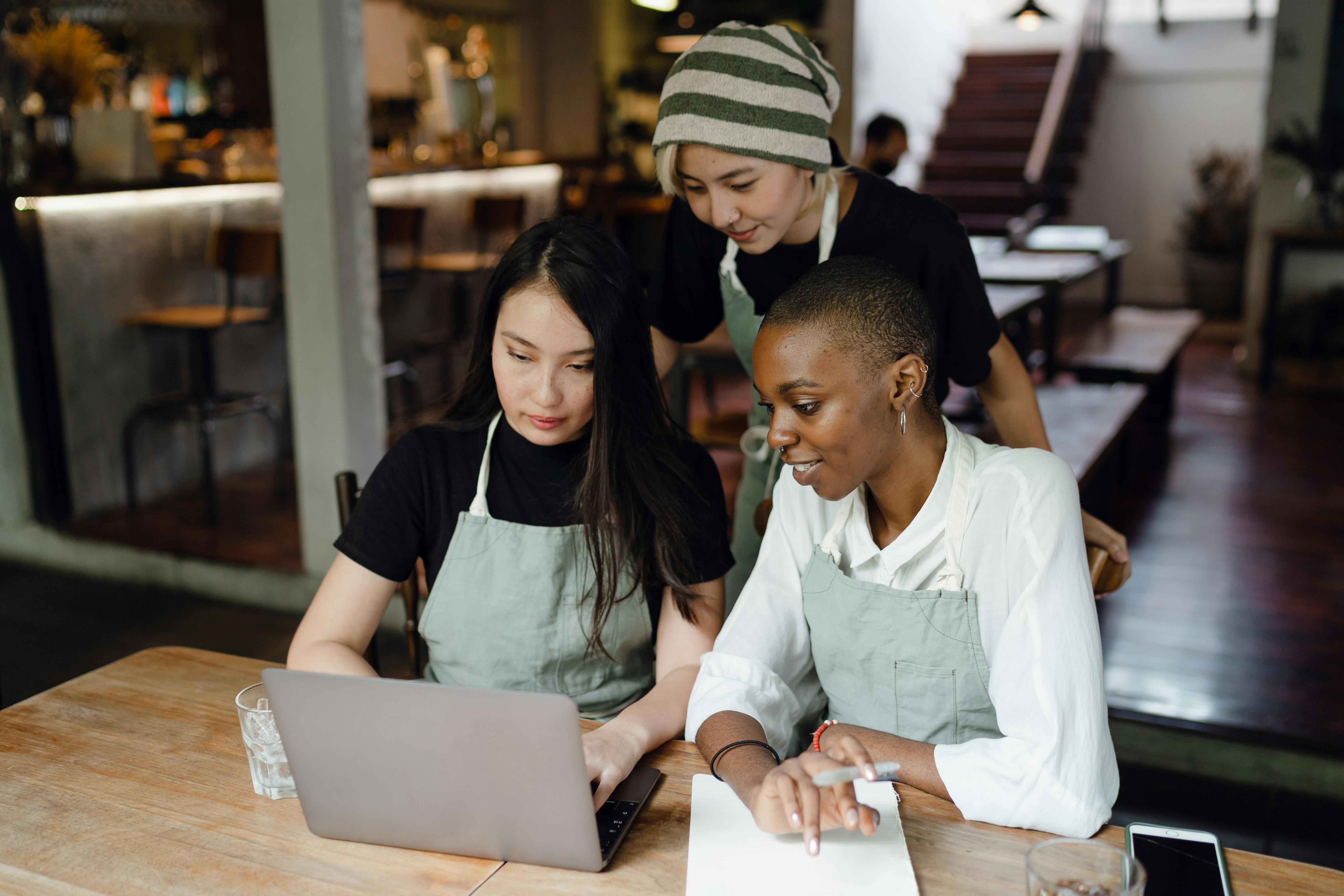 Two web designers collaborating on a website layout for a local business.